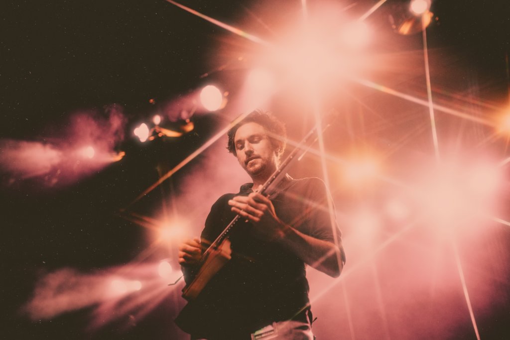 Plini playing guitar on stage