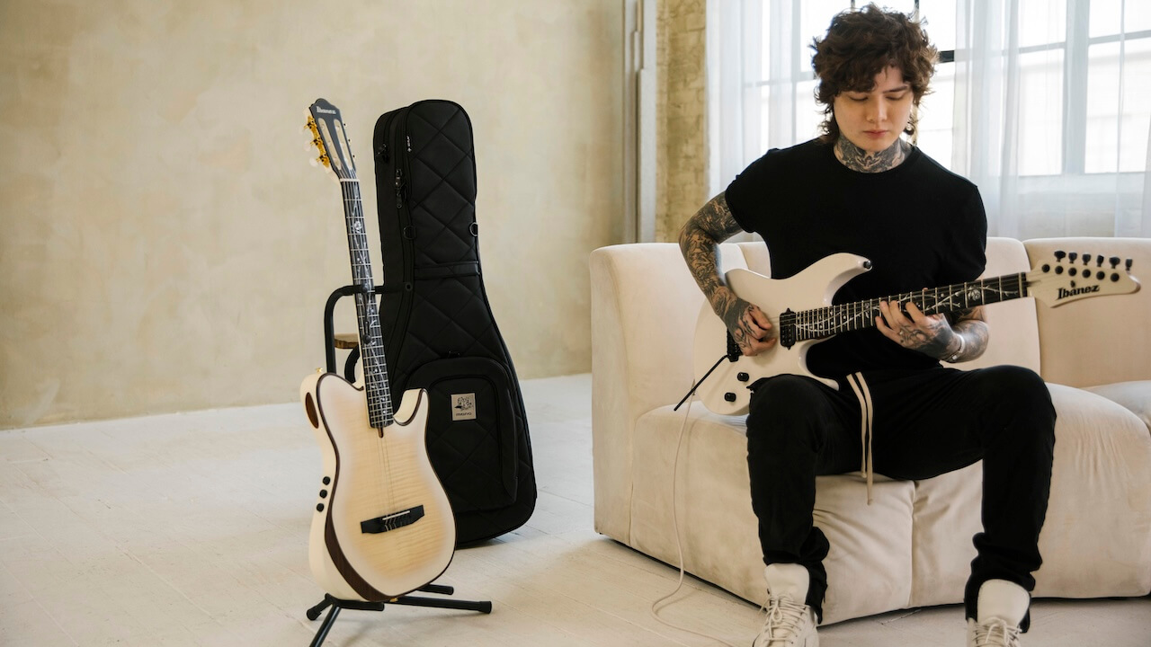 Tim Henson playing guitar with MONO x Tim Henson dual case